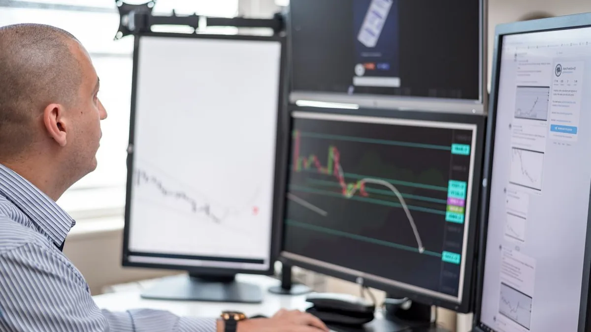 Un trader devant plusieurs écrans de cotation