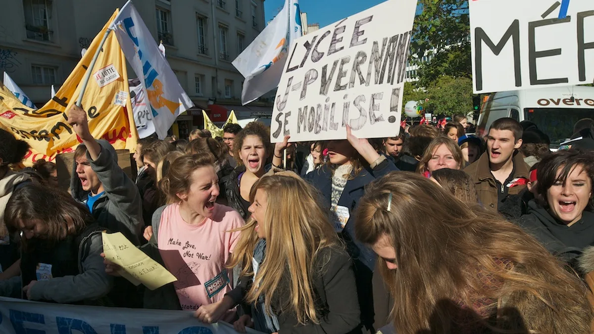 Des lycéens manifestent avec des pancartes dans une rue de Paris