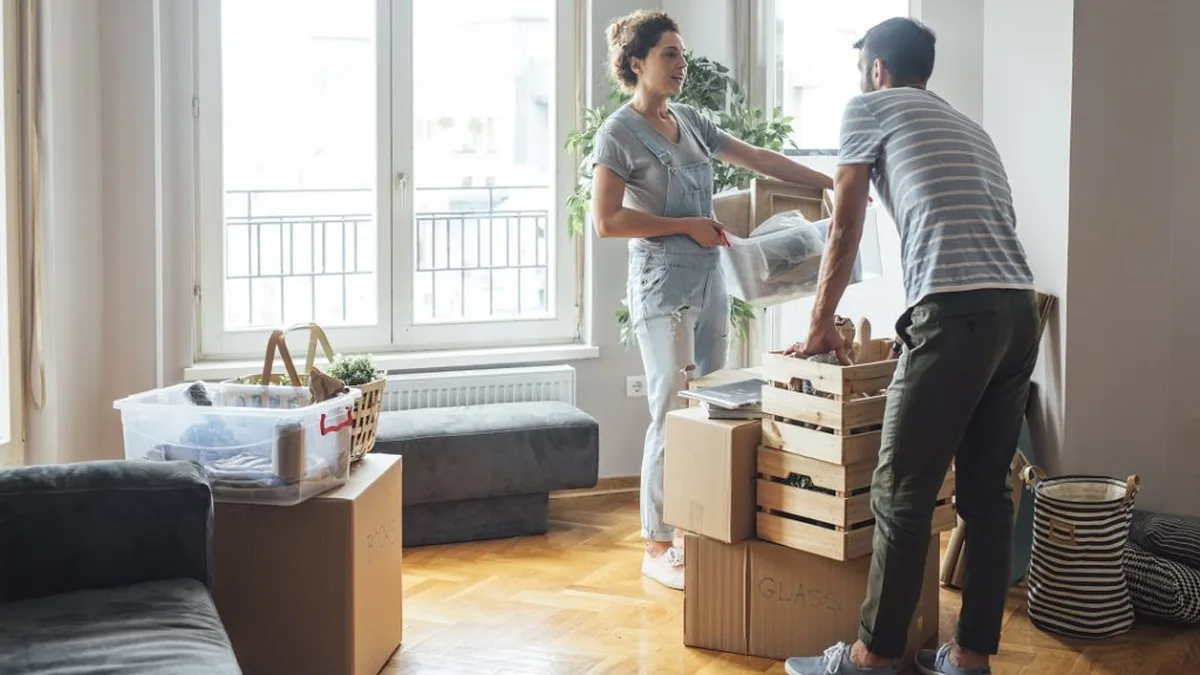 Un jeune couple déballe ses cartons dans son nouvel appartement